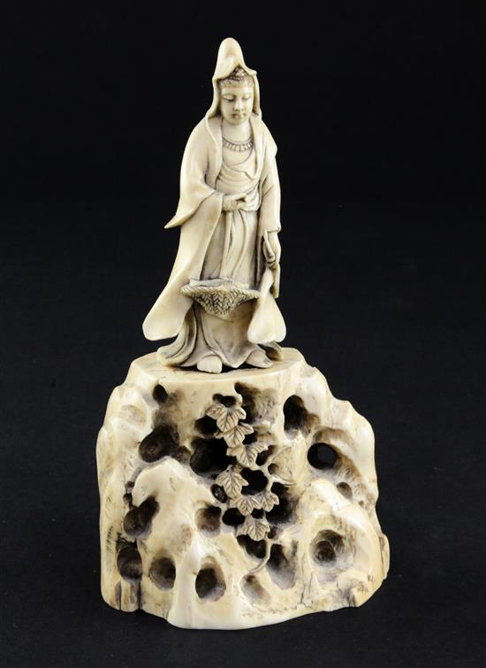 A Japanese ivory figure of Kwannon standing on rockwork, early 20th century, 14.5cm